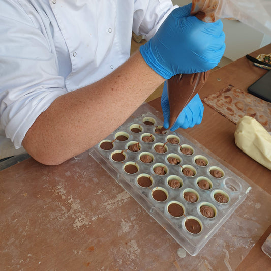 Chocolatier preparing salted caramel bonbons